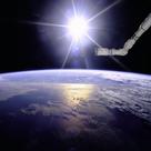 Robot arm over Earth with sunburst